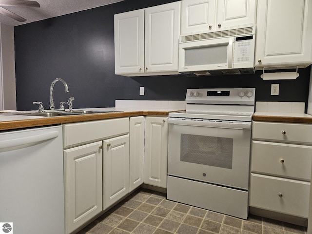 100 Fourth Ave Unit E-3, Tawas City, MI 48763 - kitchen featuring white cabinets, a sink, a textured ceiling, white appliances, and ceiling fan