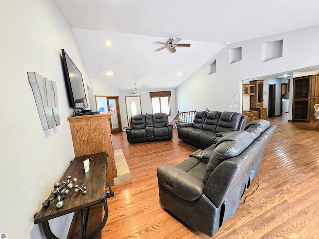 living area featuring high vaulted ceiling, ceiling fan, and light wood-type flooring