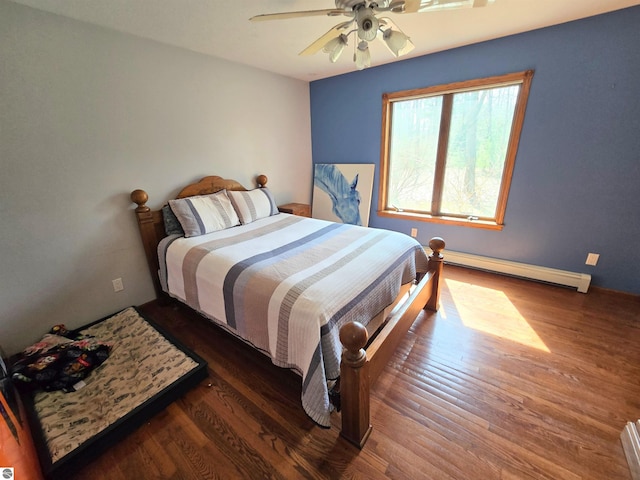 bedroom with a baseboard heating unit, a ceiling fan, and wood finished floors