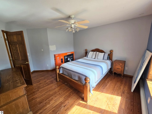bedroom with wood finished floors, a ceiling fan, and baseboards