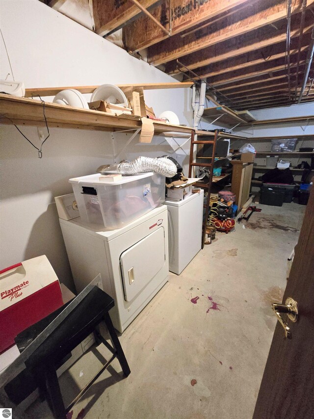 unfinished below grade area with washer and clothes dryer