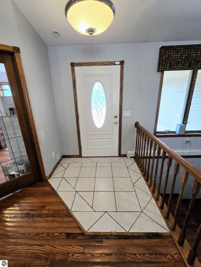 foyer entrance with baseboards and light tile patterned floors