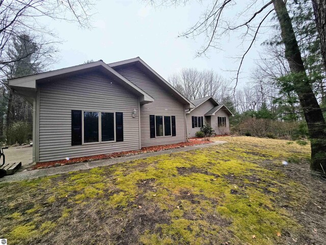 rear view of property with a yard