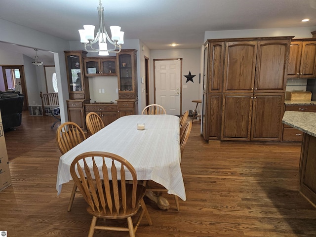 dining area with dark wood-type flooring, recessed lighting, and a chandelier