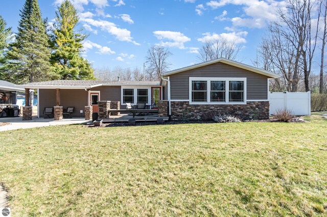 3901 W Thendara Dr, Gladwin, MI 48624 - view of front facade featuring fence, a wooden deck, and a front lawn