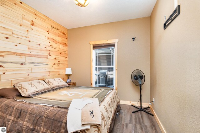 3901 W Thendara Dr, Gladwin, MI 48624 - bedroom featuring baseboards and wood finished floors