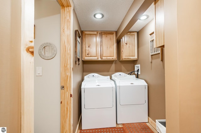 3901 W Thendara Dr, Gladwin, MI 48624 - washroom with separate washer and dryer, baseboards, cabinet space, and a textured ceiling