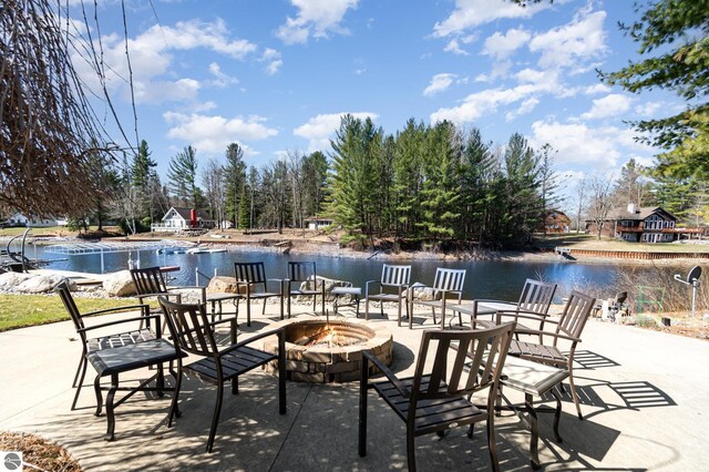 3901 W Thendara Dr, Gladwin, MI 48624 - view of patio / terrace with a fire pit and a water view