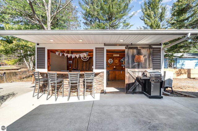 3901 W Thendara Dr, Gladwin, MI 48624 - view of patio featuring grilling area and outdoor dry bar
