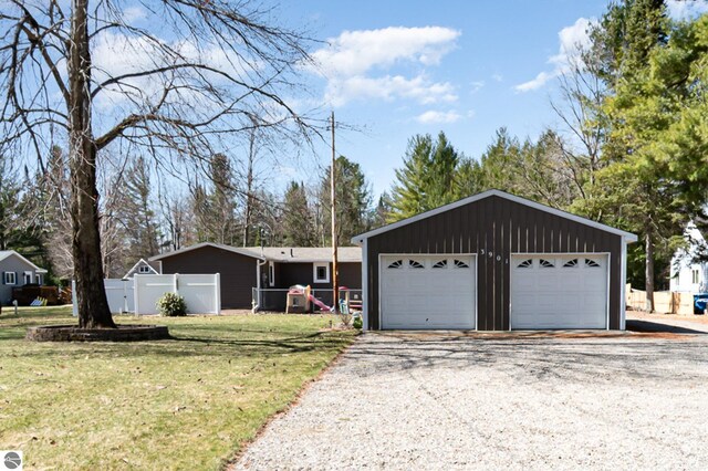 3901 W Thendara Dr, Gladwin, MI 48624 - view of front of house with fence, a front yard, and a detached garage