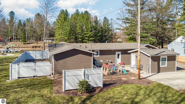3901 W Thendara Dr, Gladwin, MI 48624 - rear view of house featuring a gate, fence private yard, and a lawn
