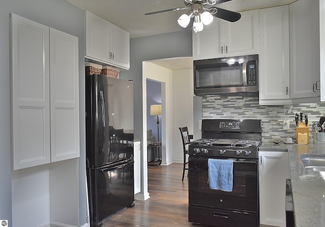 kitchen featuring dark wood-style floors, tasteful backsplash, white cabinetry, a ceiling fan, and black appliances