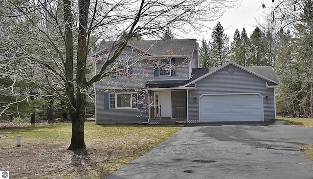view of front facade featuring an attached garage, driveway, and a front lawn