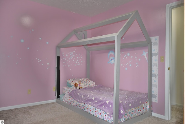 carpeted bedroom featuring baseboards