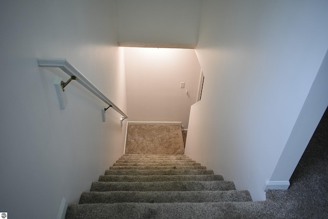 stairway with carpet and baseboards