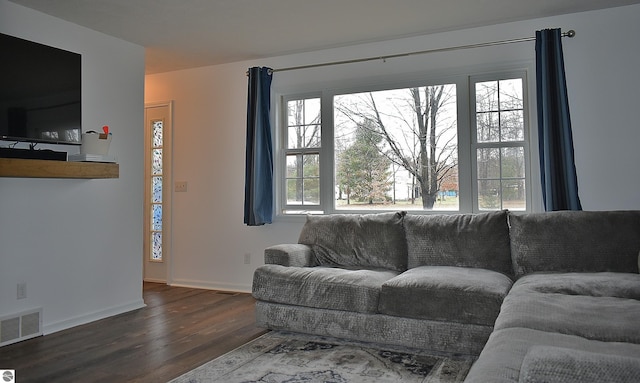 living room with baseboards, wood finished floors, and visible vents