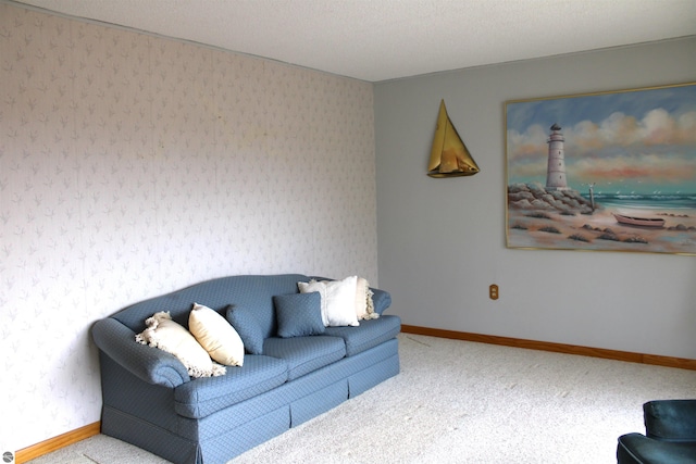 living room featuring carpet floors, wallpapered walls, and baseboards