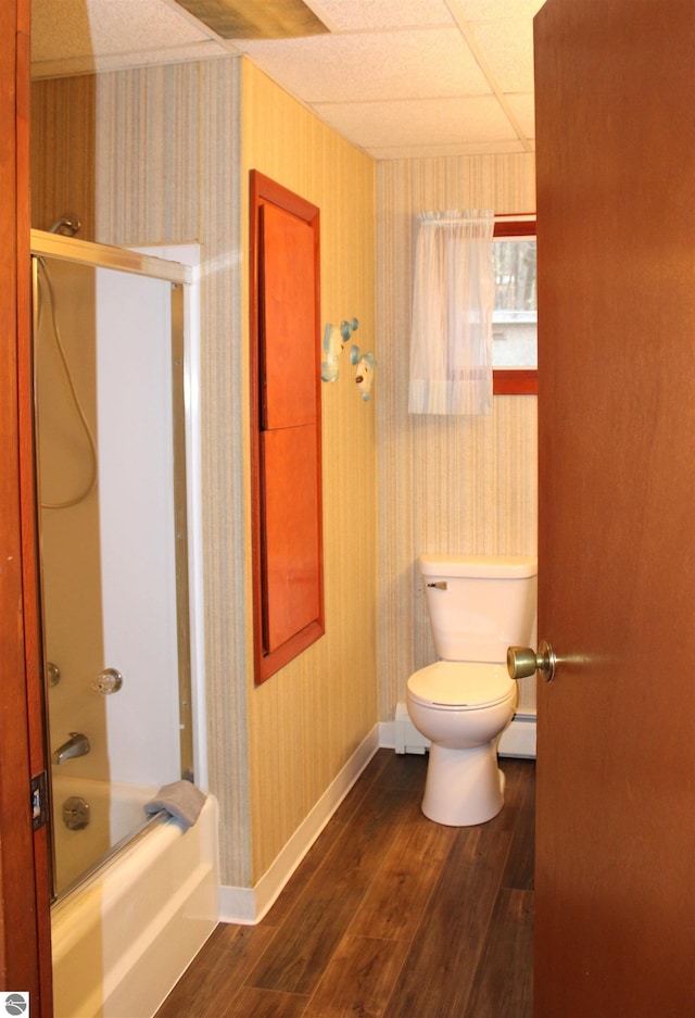 bathroom with baseboard heating, toilet, wood finished floors, and wallpapered walls