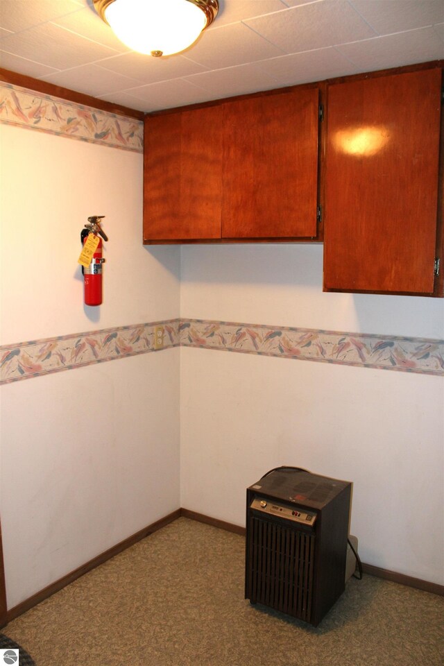interior space with brown cabinets, carpet flooring, and baseboards