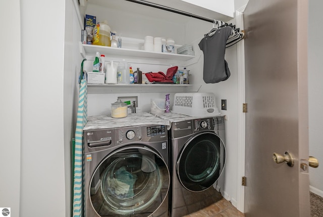 laundry area with separate washer and dryer, baseboards, and laundry area