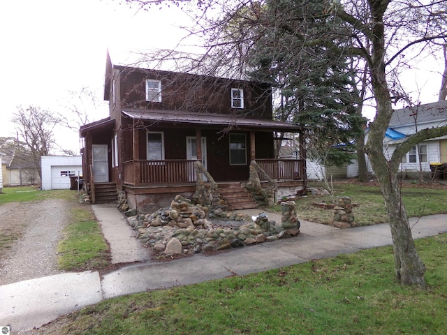 116 N Main St, Saint Louis, MI 48880 - view of front facade featuring a porch, driveway, an outdoor structure, and metal roof