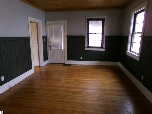 116 N Main St, Saint Louis, MI 48880 - spare room with hardwood / wood-style floors, a healthy amount of sunlight, wooden ceiling, and wainscoting