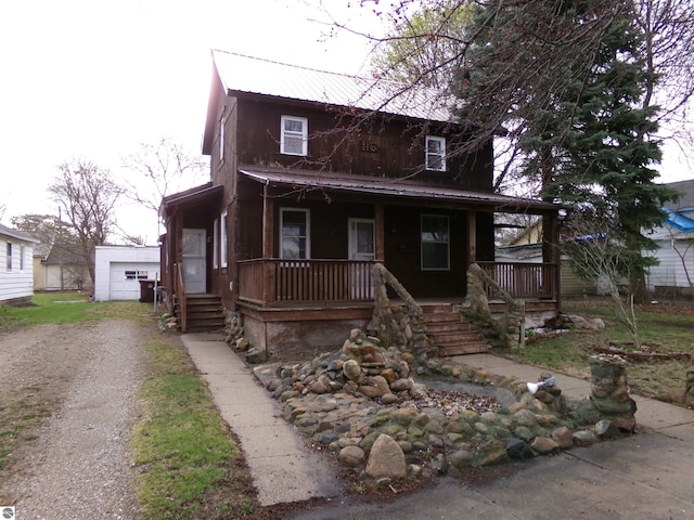 116 N Main St, Saint Louis, MI 48880 - view of front of property with a porch, dirt driveway, and metal roof