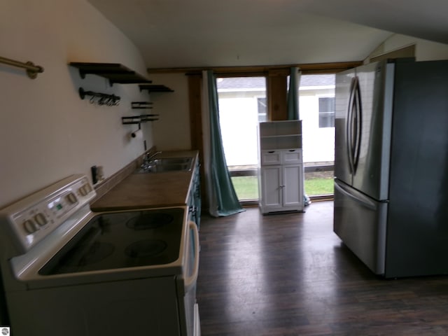 116 N Main St, Saint Louis, MI 48880 - kitchen featuring dark wood-style flooring, vaulted ceiling, freestanding refrigerator, open shelves, and electric stove