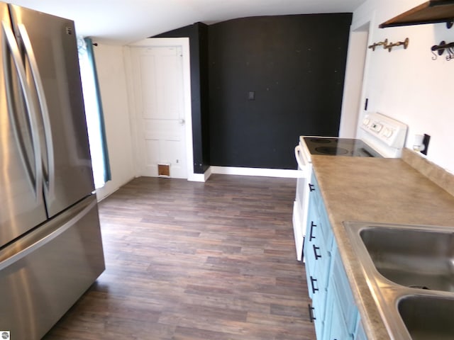 116 N Main St, Saint Louis, MI 48880 - kitchen with dark wood-style floors, electric stove, a sink, freestanding refrigerator, and baseboards