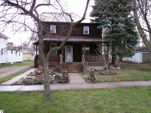 116 N Main St, Saint Louis, MI 48880 - view of front of house with covered porch and a front yard