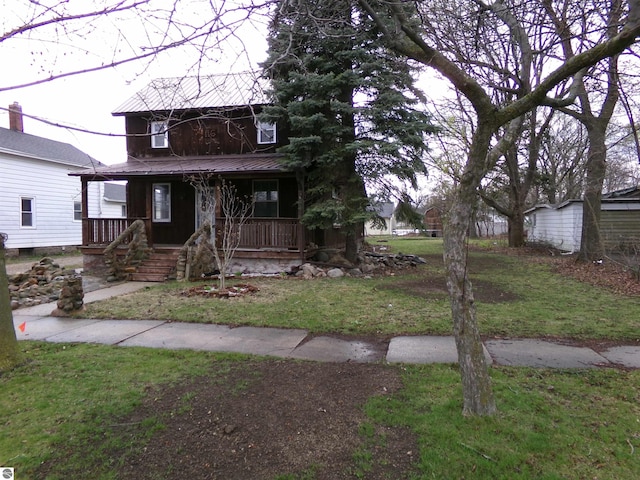 116 N Main St, Saint Louis, MI 48880 - view of front of house with a front yard, metal roof, and covered porch