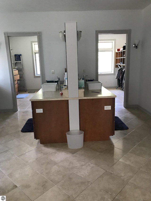 5343 Michibay Dr, Manistique, MI 49854 - bathroom featuring a walk in closet, tile patterned flooring, and vanity