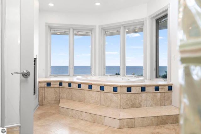 5343 Michibay Dr, Manistique, MI 49854 - bathroom with a bath, a water view, tile patterned floors, and a wealth of natural light
