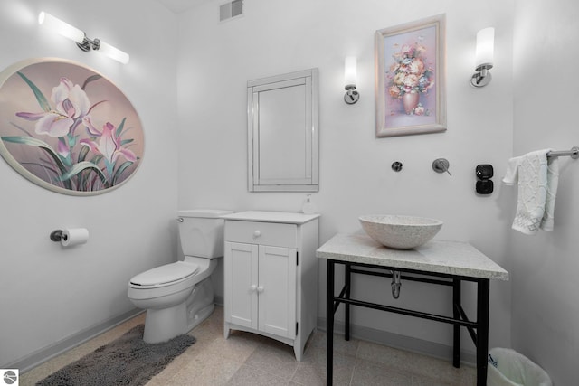 5343 Michibay Dr, Manistique, MI 49854 - bathroom featuring toilet, vanity, granite finish floor, baseboards, and visible vents