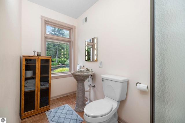 5343 Michibay Dr, Manistique, MI 49854 - half bath featuring baseboards, toilet, visible vents, and a wealth of natural light