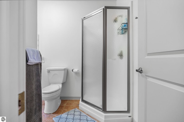 5343 Michibay Dr, Manistique, MI 49854 - bathroom featuring tile patterned floors, baseboards, a shower stall, and toilet