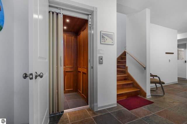 5343 Michibay Dr, Manistique, MI 49854 - staircase with baseboards, stone tile floors, and elevator