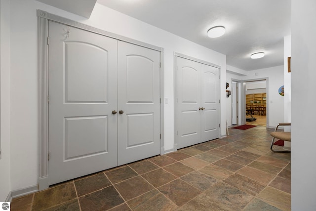 5343 Michibay Dr, Manistique, MI 49854 - corridor featuring baseboards and stone tile floors
