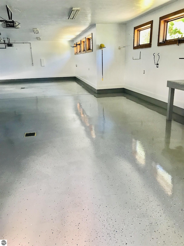 5343 Michibay Dr, Manistique, MI 49854 - garage featuring visible vents and baseboards