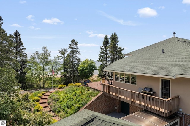 5343 Michibay Dr, Manistique, MI 49854 - exterior space with a wooden deck, roof with shingles, and stucco siding