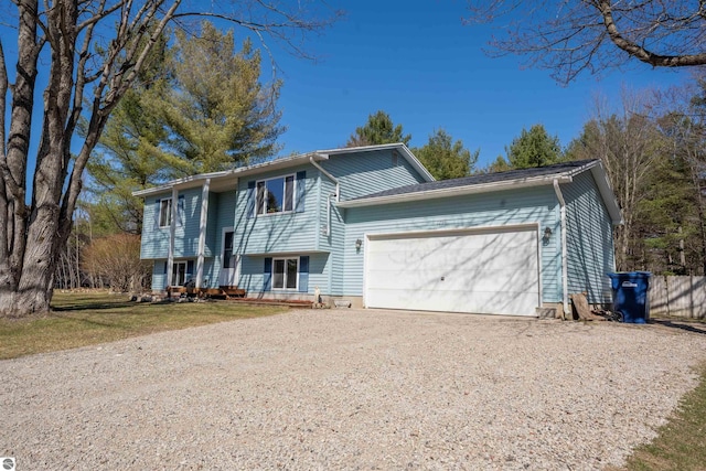 1294 Fisher Rd, Traverse City, MI 49685 - bi-level home featuring an attached garage and dirt driveway