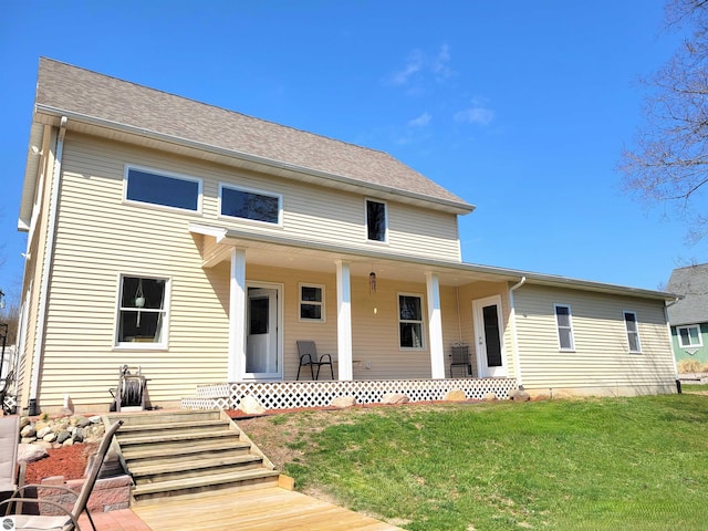 734 N Rolland Rd, Lake Isabella, MI 48893 - back of property featuring a porch and a lawn