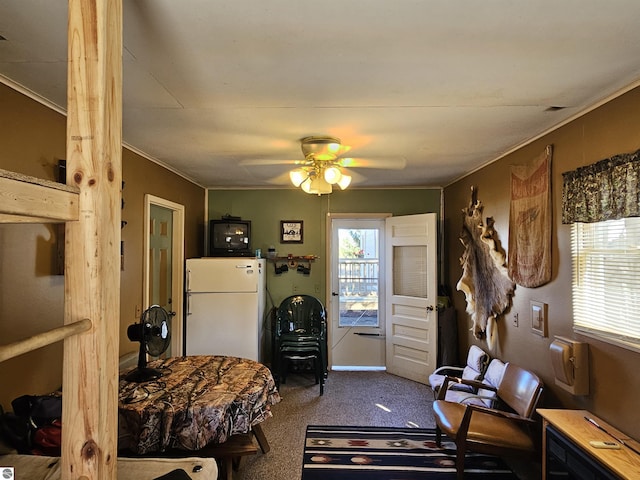 bedroom with a ceiling fan, carpet floors, crown molding, and freestanding refrigerator