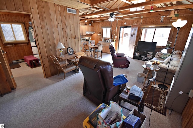 8991 W Oak Ln, Lake City, MI 49651 - living room featuring carpet, wood walls, ceiling fan, and wood ceiling