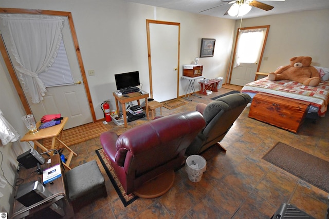 8991 W Oak Ln, Lake City, MI 49651 - living area featuring a ceiling fan and stone finish flooring