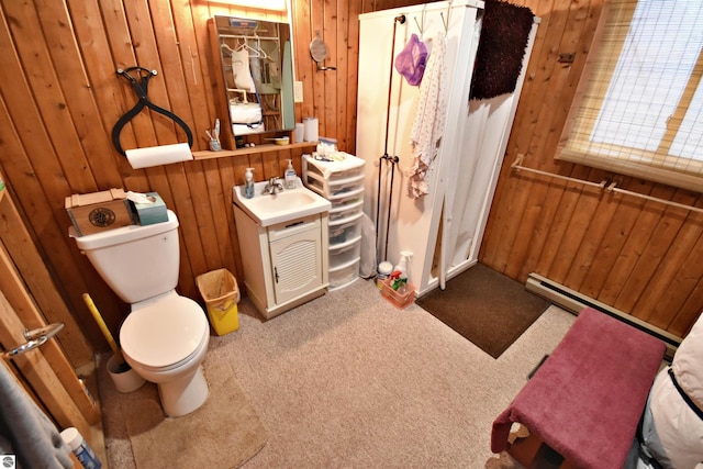 8991 W Oak Ln, Lake City, MI 49651 - bathroom with wooden walls, toilet, vanity, and carpet flooring