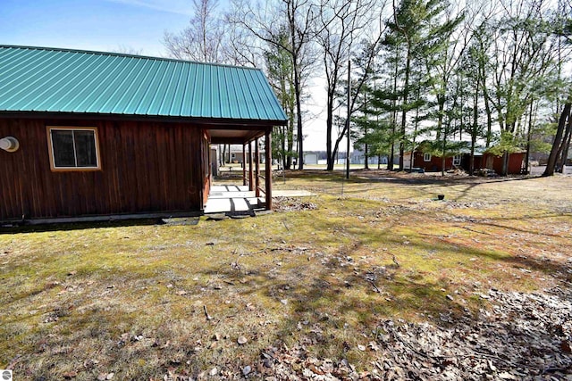 8991 W Oak Ln, Lake City, MI 49651 - view of property exterior featuring metal roof