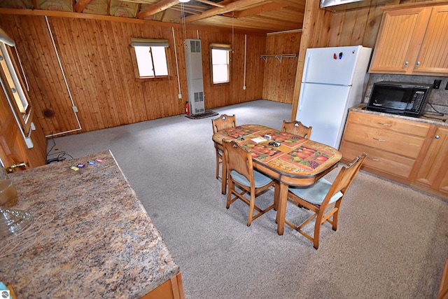 8991 W Oak Ln, Lake City, MI 49651 - dining area featuring wooden walls and light colored carpet