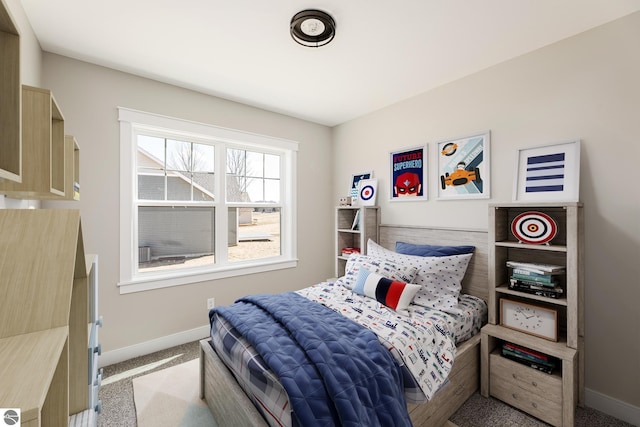 carpeted bedroom featuring baseboards