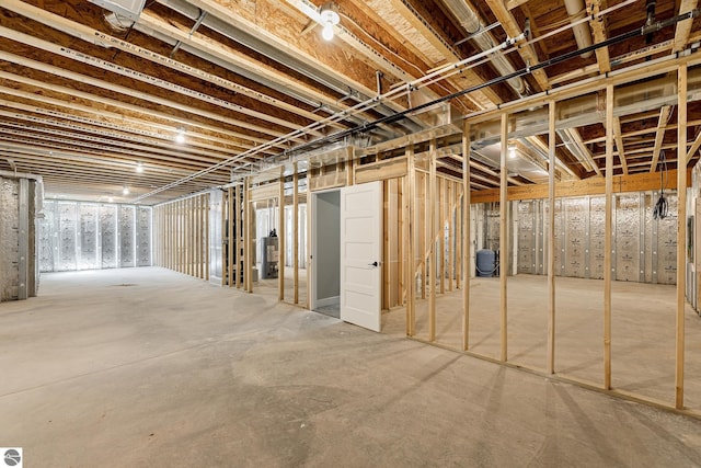 unfinished below grade area featuring water heater